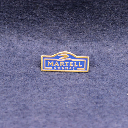 Vintage Martell Cognac enamel pin in blue and gold.