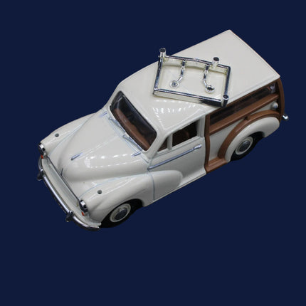 Die Cast model of a vintage Morris  car with a cream body and wooden sides on a dark background