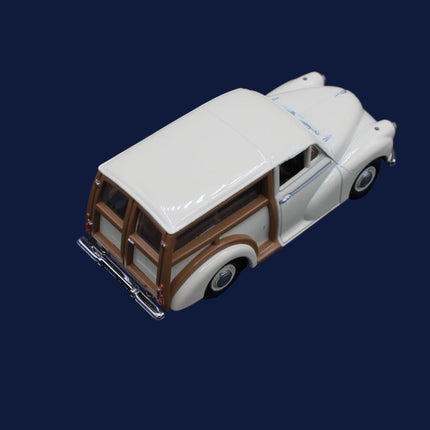 Model of a vintage car with a white roof and brown body on a dark background