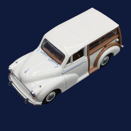 Model of a vintage car with white body and wooden side panels on a dark background