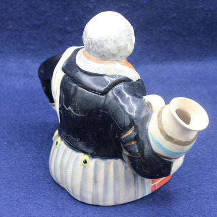 Ceramic figure of a person with a backpack on a blue background