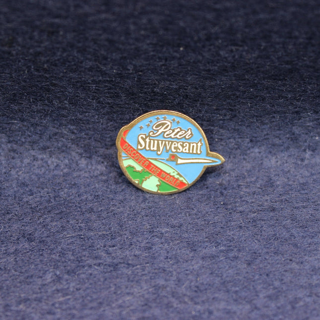 Vintage Peter Stuyvesant enamel badge with aircraft and travel design