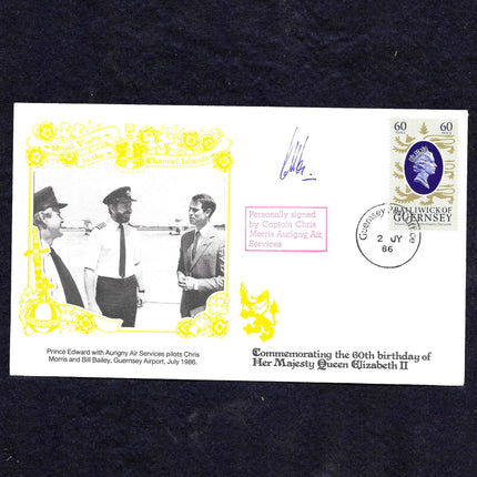 A commemorative airmail stamp envelope from the United Kingdom, commemorating the 80th birthday of Her Majesty Queen Elizabeth II. The white envelope features a yellow border, a black-and-white historical photo of Captain Chris Morris and two passengers, a purple Queen Elizabeth II portrait stamp, and a black postmark.