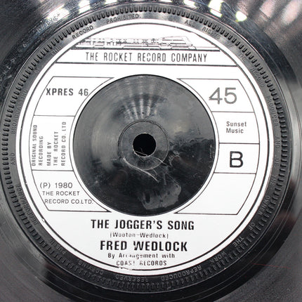 Close-up of a vinyl record label with text and branding.