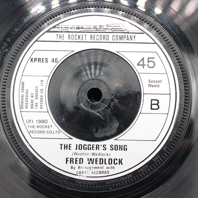 Close-up of a vinyl record label with text and branding.