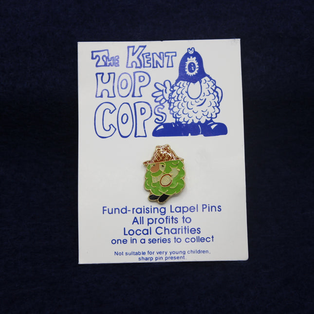 Kent Hop Cops fund-raising lapel pin on a card with a dark background
