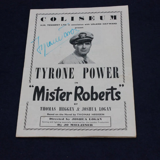A vintage printed program or booklet cover for the theatrical production 'Coliseum: Tyrone Power in "Mister Roberts"' on a dark navy background. The white cover features black typography, a portrait of Tyrone Power in uniform, and a blue autograph across the upper left.