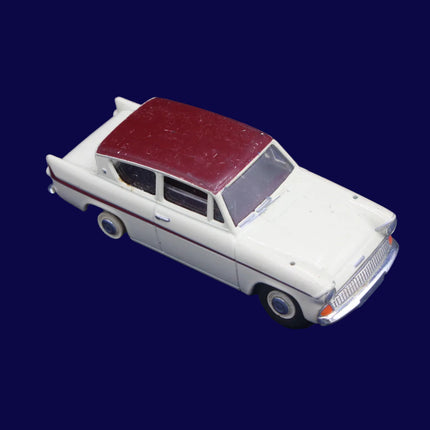Model car with a maroon roof on a blue textured background