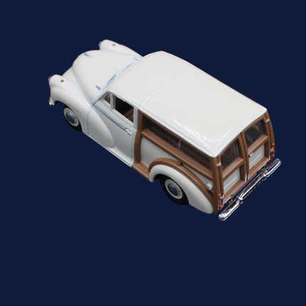 Model of a vintage white and brown car on a dark blue background