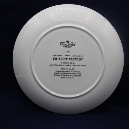 White Coalport plate with engraved text on a black background
