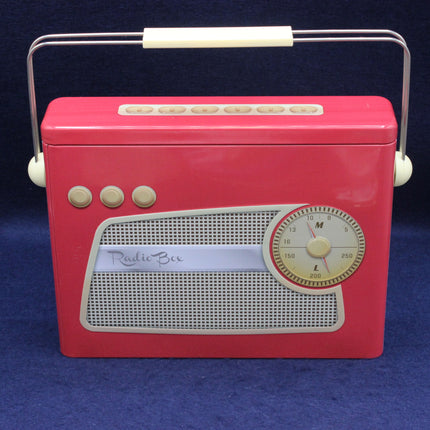 Vintage-style red radio biscuit tin with a white handle on a blue background