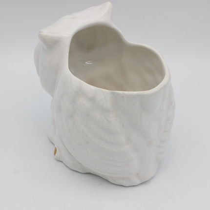 A white ceramic owl-shaped planter with a textured feather pattern and an open top, photographed on a seamless light gray background.