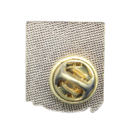 Gold pin with a letter 'S' on a blue textured background