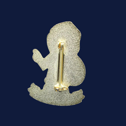 Metallic Santa Golly  badge or pin on a blue textured background
